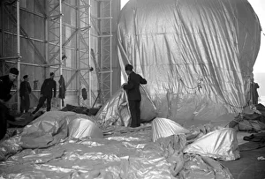 Preparations Prints: Barrage Balloon being filled in its hangar at Hook, Surrey. October 1938