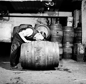 A barrel inspector at work at Hancocks Brewery in Cardiff. July 1952 C3603-002