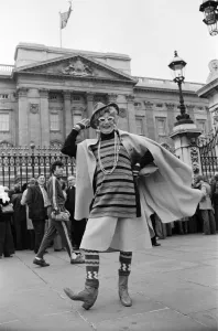 Barry Humphries in character as Dame Edna Everage outside Buckingham Palace, London
