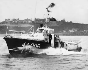 The Barry lifeboat speeds away from Barry docks on its annual trip to take Christmas food