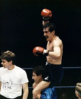 Barry McGuigan Boxing is lifted on to the shoulders of his trainer Jimmy Tibbs after