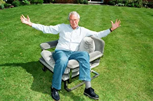 Barry Norman Film Critic seen here in the garden of his Datchworth home with the chair he