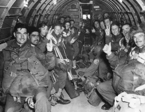 Holland Prints: The Battle of Arnhem. British Troops fill a C46 transport plane to land with the first
