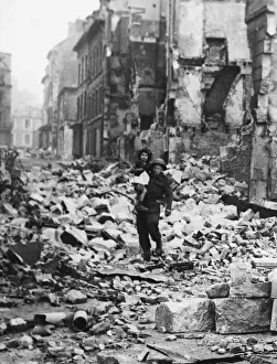 Ruins Prints: The Battle for Normandy: A British soldier carries a little girl through the devastation
