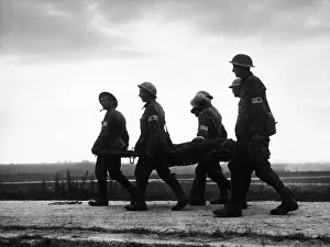 Casualty Prints: Battle of the Somme: A stretcher case seen in silhouette being brought in from La