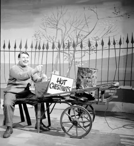 Presenters Prints: BBC broadcaster and presenter Johnny Morris as the Hot Chestnut man during the filming of