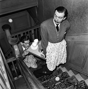 Scriptwriter Prints: BBC comedy scriptwriters Frank Muir and Denis Norden bringing a tray of tea up the stairs
