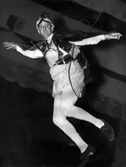 Commentators Prints: BBC Commentator Brian Johnston takes a practice flight through the air at the Empress
