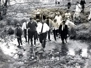Walk Prints: Beating the bounds - Llantrisant - Townspeople wade through a small brook led by Eddie