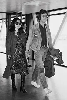 Couples Prints: Former Beatle John Lennon with his wife Yoko Ono leaving Heathrow Airport for the Cannes