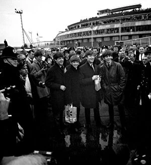 00105 Collection: The Beatles arrive at London airport from Sweden. Surrounded by police, press and fans