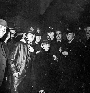 The Beatles dressed in policemen helmets used to smuggle them into the Birmingham