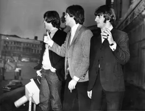The Beatles enjoy a cigarette break on the balcony of the Empire Theatre in Liverpool 8th