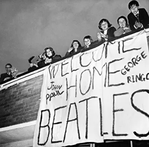 Banner Prints: Beatles fans at London Heathrow Airport look forward to welcoming home The Beatles