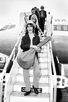 Beatles guitarist George Harrison complete with sitar at Heathrow