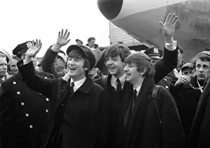 Beatles l-r: John Lennon, Paul McCartney and Ringo Starr wave to fans upon their arrival