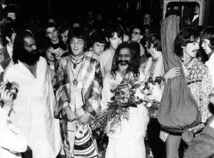 Hippy Prints: The Beatles with the Maharishi Mahesh Yogi who is clutching bundles of flowers Beatles