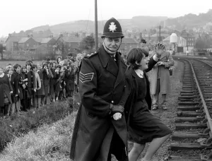 The Beatles March 1964 A policeman escorts away school children try to meet