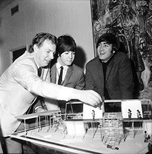 Beatles Paul McCartney (centre) and John Lennon are shown the stage set of a new show