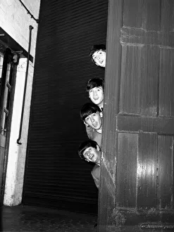 The Beatles peering out from behind a door before the groups appearence at Sunday Night
