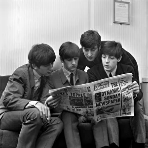 Beatles pop grouo reading the Sunday Mirror newspaper. Left to right