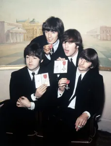 Beatles Colour Prints: The Beatles pose with their MBEs at a press conference held at the Saville Theatre