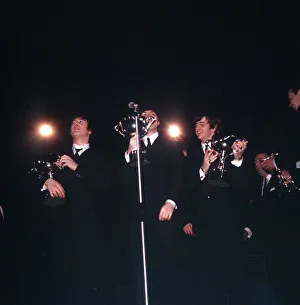 The Beatles receiving awards from Roger Moore at the NME Poll Winners All Star concert