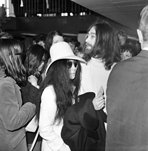 Beatles singer songwriter John Lennon and wife Yoko Ono pictured at Heathrow today