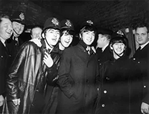The Beatles wearing Policemens helmets in Birmingham after concert at the Hippodrome