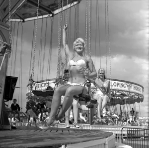 00082 Prints: Beauty contest girls at Clacton Butlins on a fairground ride. 19th July 1959