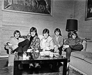 The Bee Gees seen here watching television in their hotel room 17th October 1967