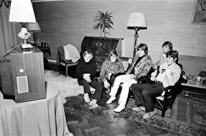 The Bee Gees seen here watching television in their hotel room 17th October 1967