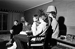 The Bee Gees seen here watching television in their hotel room 17th October 1967