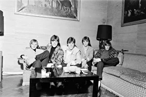 The Bee Gees seen here watching television in their hotel room 17th October 1967