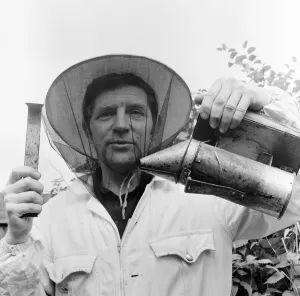 01015 Prints: Beekeeper, G Baitey, holding Smoker with heat shield and hook, Newcastle, 22nd July 1971