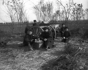 Belgian artillerymen having a meal by their gun during World War One Circa