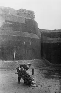 Belgium Prints: Belgian officer placing a wreath at the execution stake at a Gestapo prison in an old
