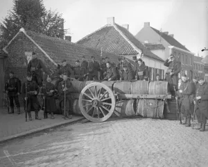 Belgian soldiers man a barriacde made of barrels in Zele following the fall of Brussels