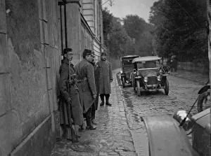 Motor Cars Prints: Belgian soldiers stand sentry at the entrance to the temporary headquarters of