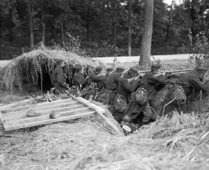 Camouflage Prints: Belgium infantry men seen here readying to fire at the approaching enemy from their