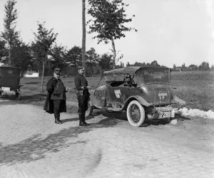 Belgium officers inspect a staff car which had been captured by the Germans along with