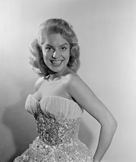 01202 Prints: Belinda Lee, British actress tries on dress designed by Julie Harris