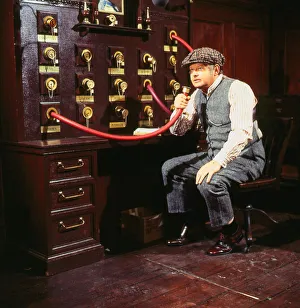 Benny Hill comedian November 1985 Sitting speaking into hose machine wearing cap