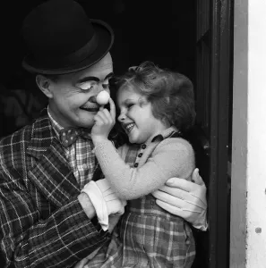 Blind Prints: Bertram Mills Circus Clown Alby Austin visiting blind children. 15th December 1951