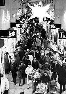 00119 Prints: Under the Bethlehem star shoppers stream along the City Arcade in Coventry