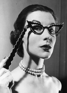 Pearls Prints: Betty Spurling who puts on TV fashion shows designs glasses February 1953