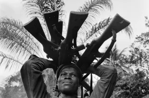 African Prints: A Biafran soldier seen here holding a selection of guns during the Biafran conflict