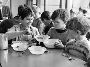 00121 Prints: Big sister Christine Howarth, aged 10 dished up pudding to brother Jim, 9