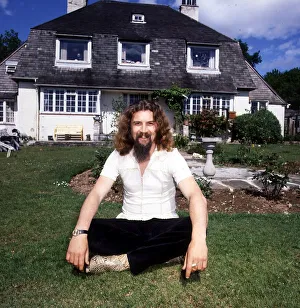 Billy Connolly 1988 Drymen sitting cross legged in front of house