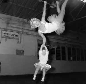 Circuses Prints: Billy Smarts Circus Trapeze artists flying through the air December 1957